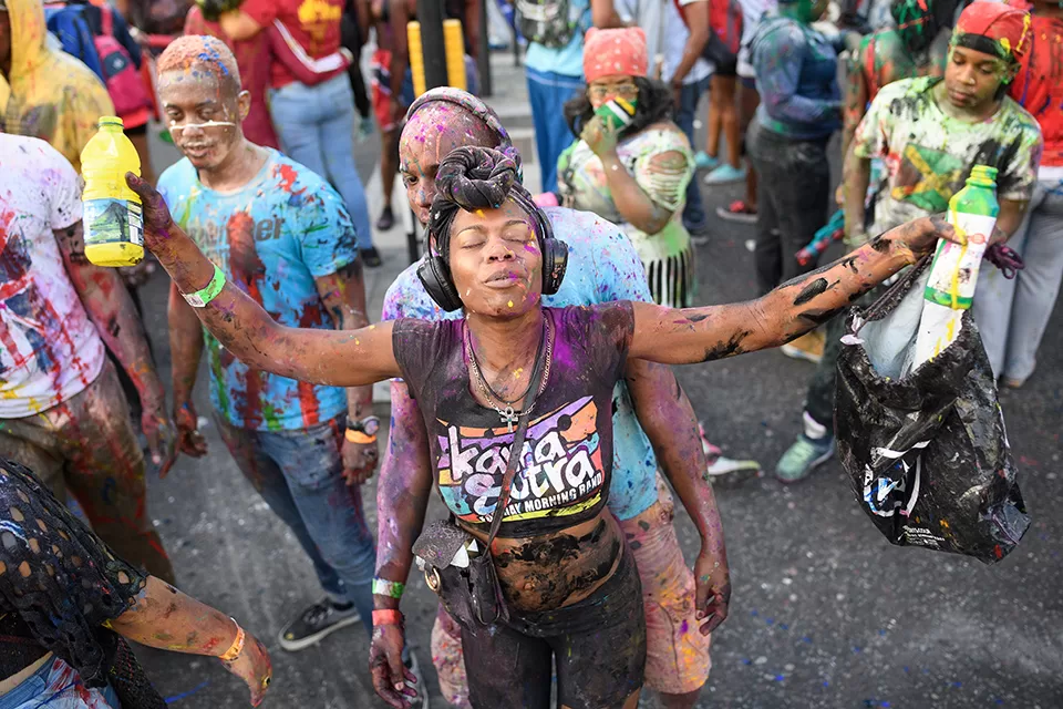 Woman at dutty mas covered in paint